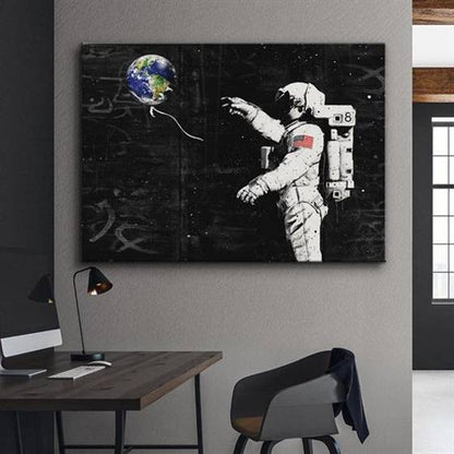 Astronaut with an earth balloon canvas