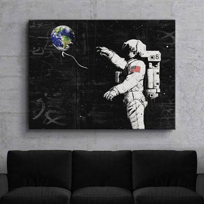 Astronaut with an earth balloon canvas