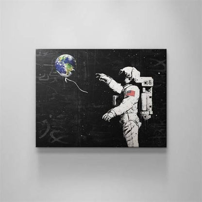 Astronaut with an earth balloon canvas