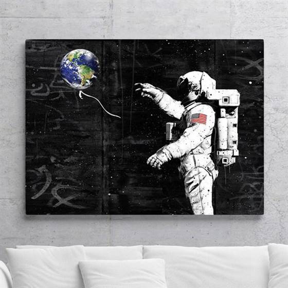 Astronaut with an earth balloon canvas