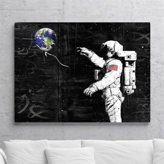 Astronaut with an earth balloon canvas